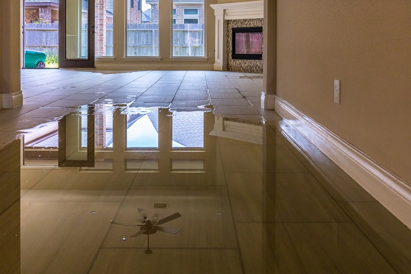 A flooded floor inside a home prior to water damage restoration service